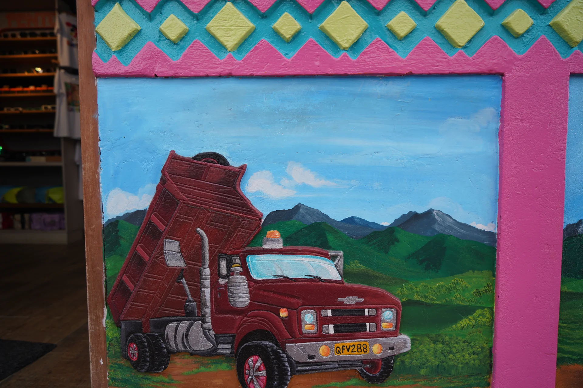 Close-up of hand-sculpted 3D zócalo relief art on a building wall in Guatapé