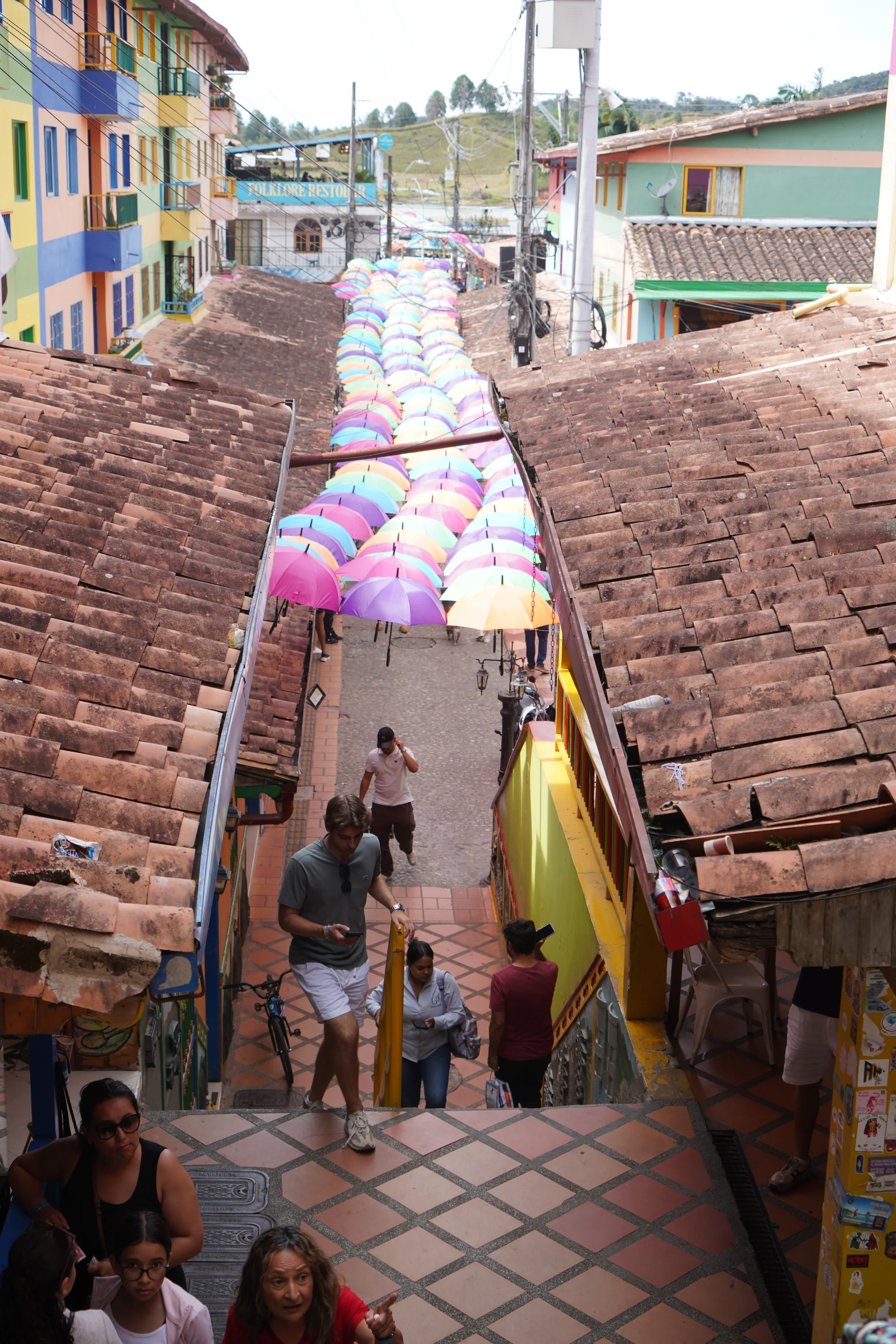 Colorful zócalo buildings on a cobblestone street in Guatapé town center