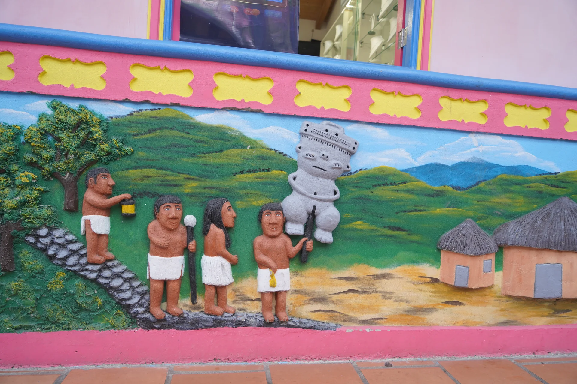 Zócalo art — Tahamí ceremony carrying a stone idol, pre-colonial Guatapé