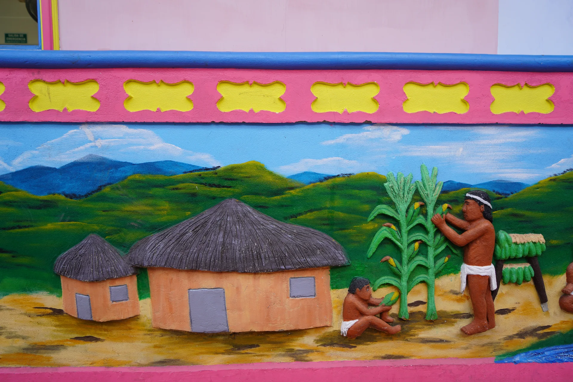 Tahamí people farming corn — zócalo panel in Guatapé