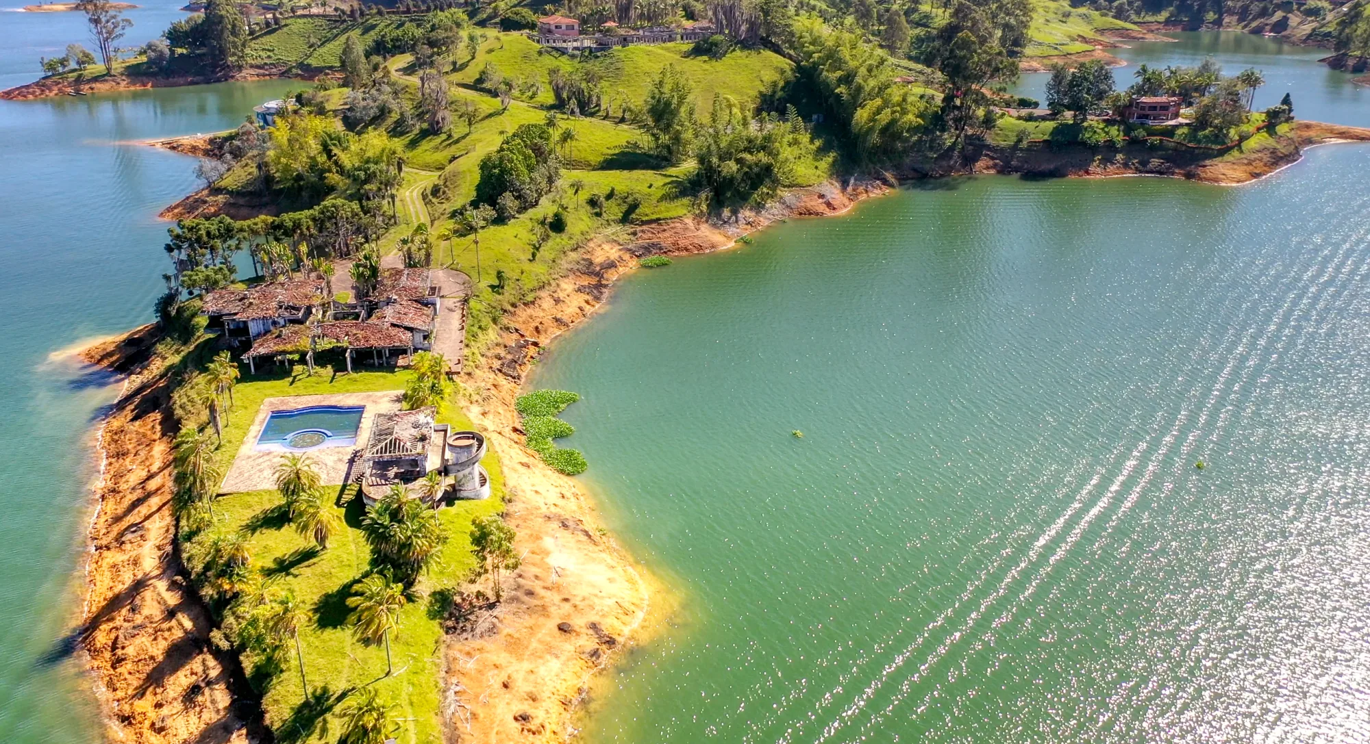 Aerial view of the ruined Finca La Manuela estate on a peninsula in the El Peñol-Guatapé reservoir